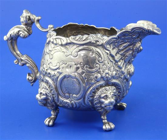 An ornate silver cream jug, 14.5 oz.